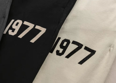 Fear of God Essentials Oatmeal Joggers with Black 1977 Graphic